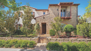 Beautiful stone-front home with lush landscaping and a welcoming entrance in Irvine, California.