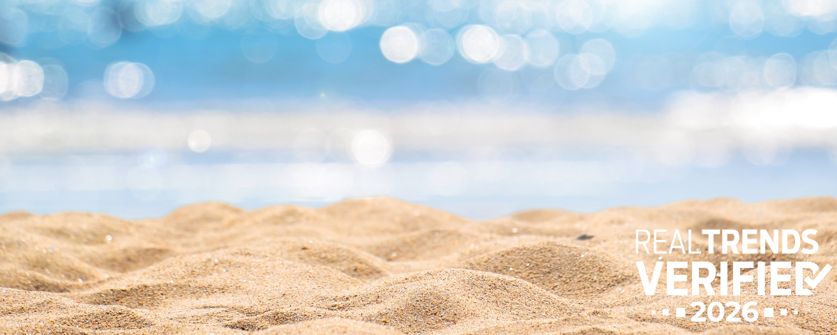 Beach sand and ocean background with RealTrends Verified 2026 graphic for a Surterre Properties blog post about top real estate agents in the United States.