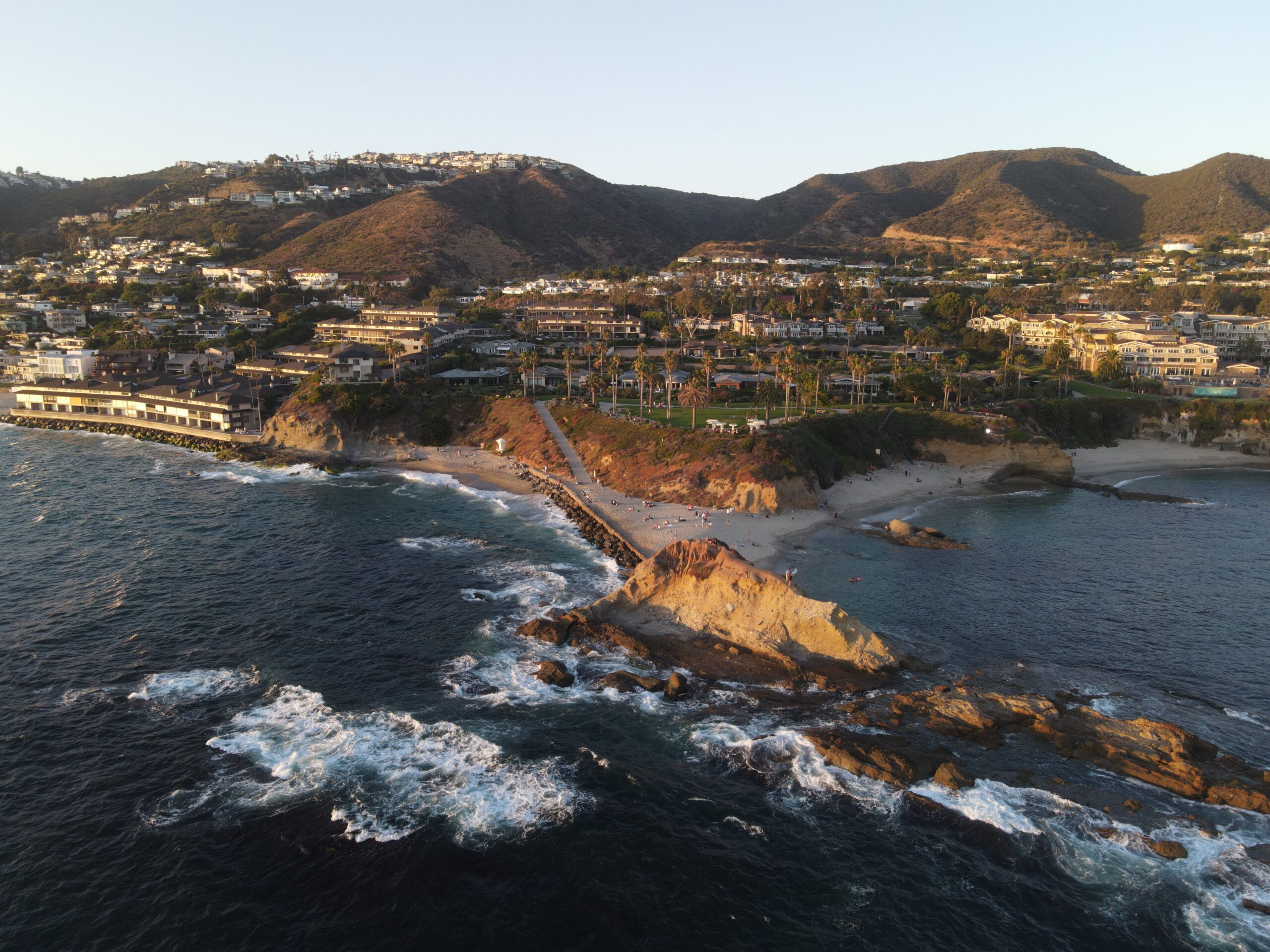 Aerial view of oceanfront homes along a rugged Southern California coastline, highlighting the long-term appeal of coastal real estate.