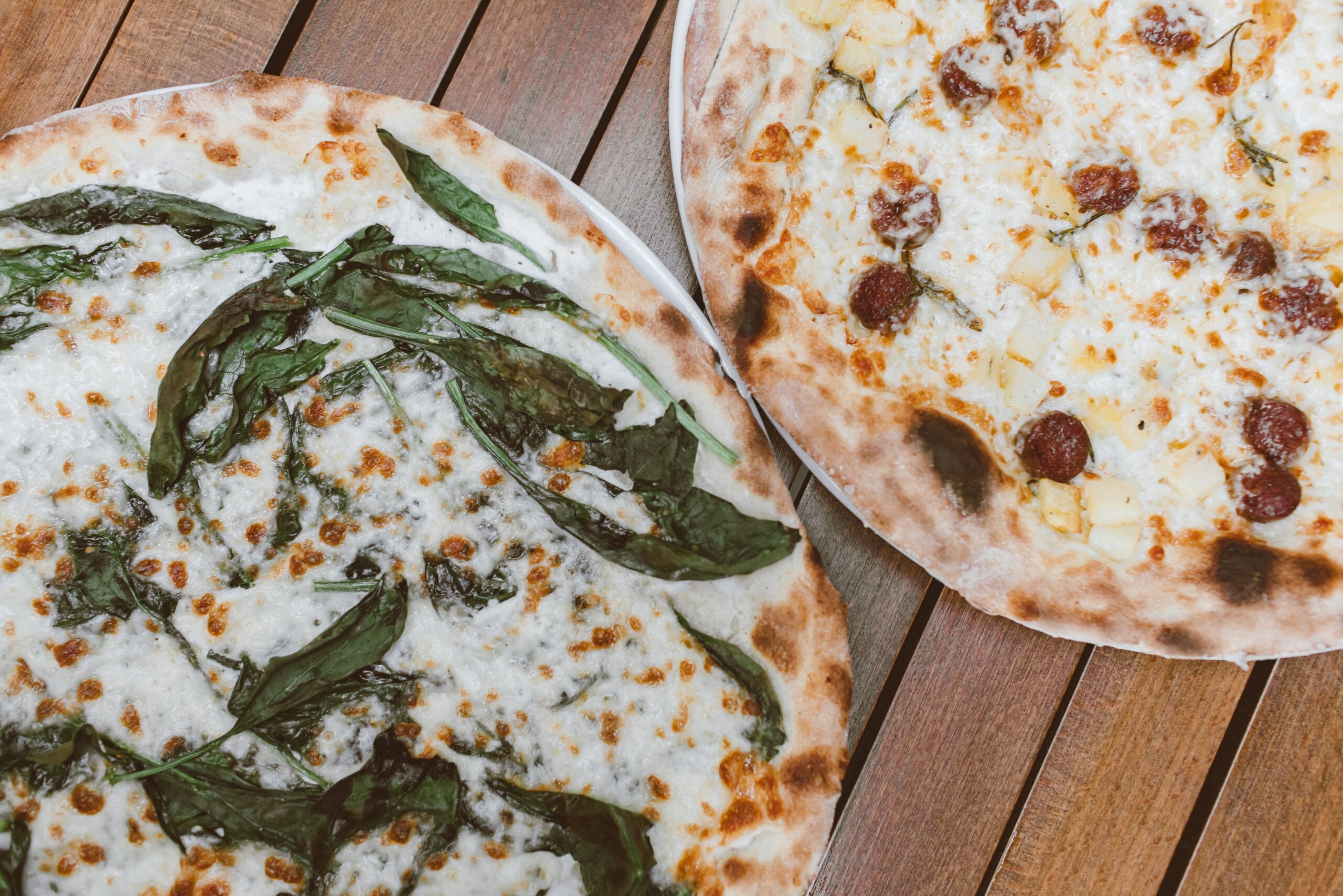 Artisan pizzas with fresh basil and gourmet toppings at an Irvine dining destination in Orange County