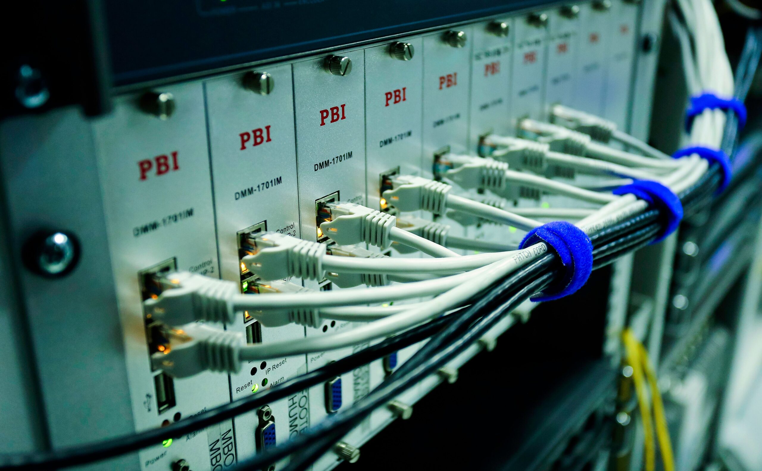 Close-up of network cables connected to data center server equipment with illuminated status lights.